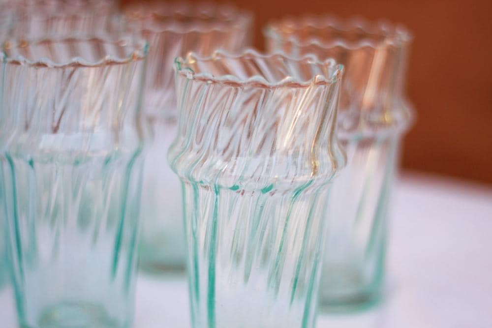 A collection of textured, clear glass tumblers with a wavy rim, House of Anouar