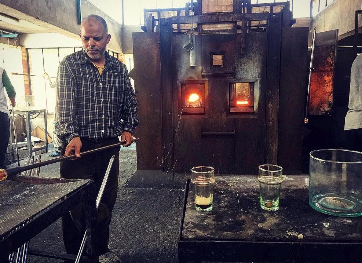 Artisan shaping a handblown Moroccan glass at a furnace, House of Anouar