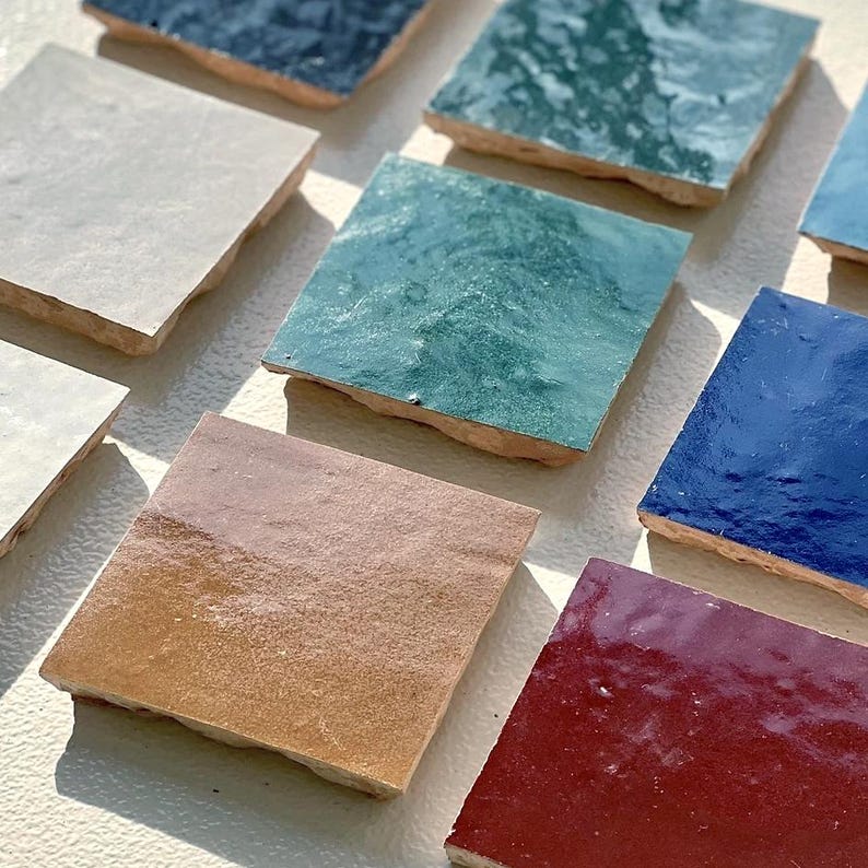 Assorted handmade Moroccan Zellige tile samples in various colors by House of Anouar