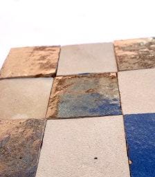 Close-up of mixed glazed and unglazed square zellige tiles, House of Anouar
