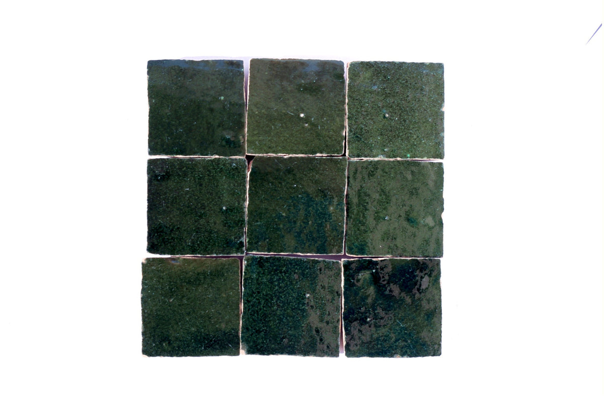 Dark-green square Moroccan zellige tiles arranged in a grid, House of Anouar