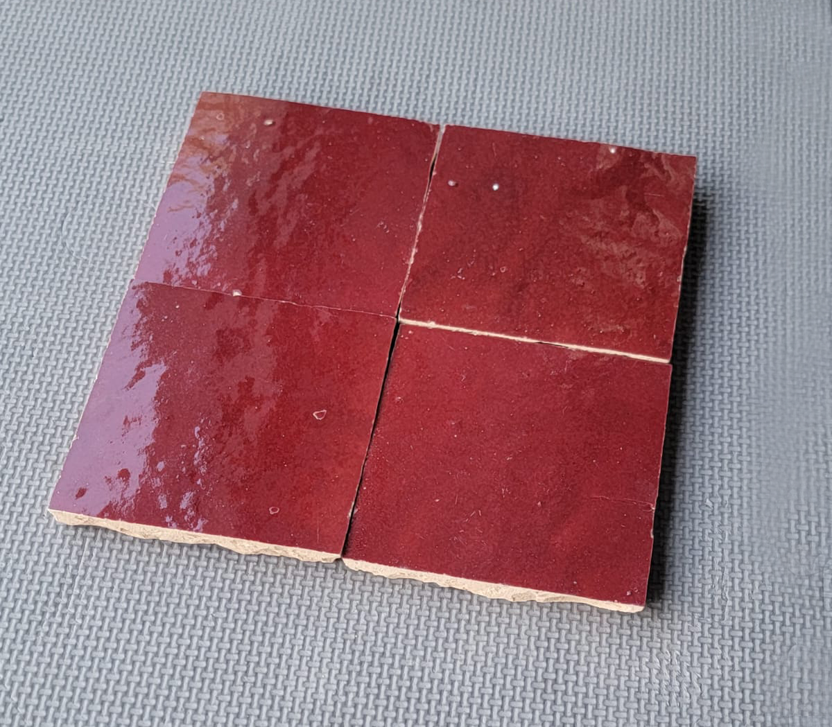 Four square burgundy red handmade Moroccan Zellige tiles with a glossy finish, House of Anouar