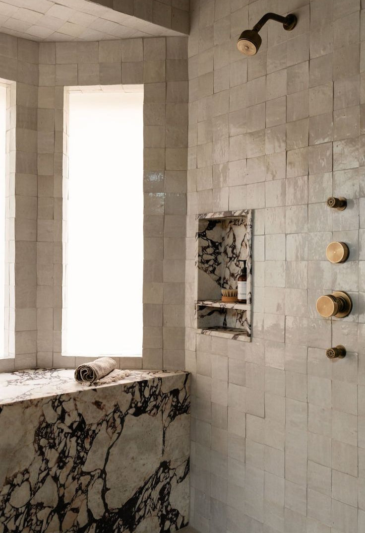 Handmade Moroccan Zellige tiles in warm beige glaze with subtle tonal variation for luxury shower wall installation in 4x4 inches 2x2 inches 10x10 cm and 5x5 cm sizes