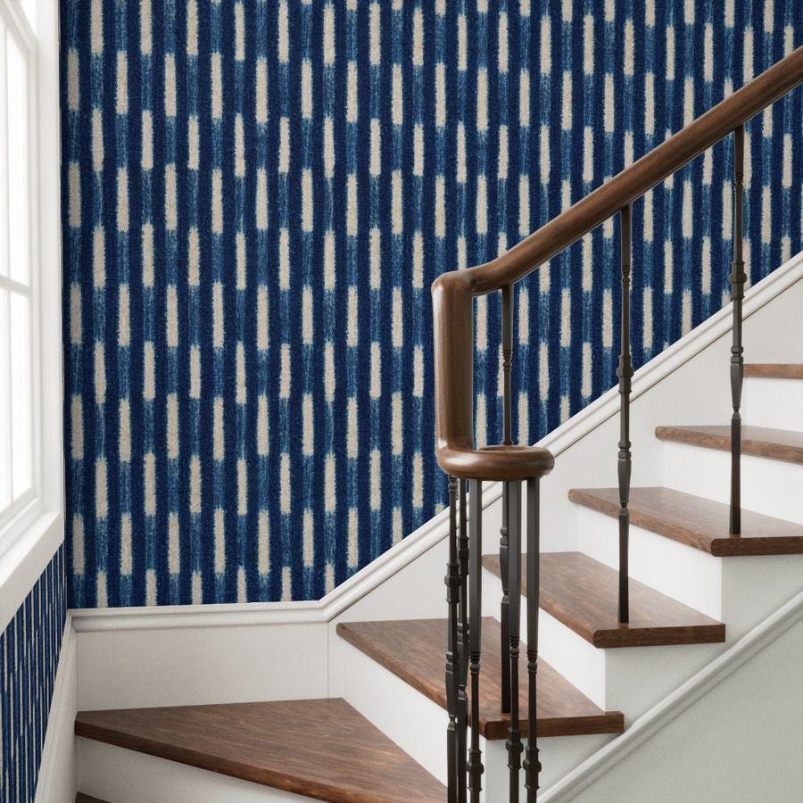 Indigo Baule strip-weave wallpaper beside a staircase, House of Anouar