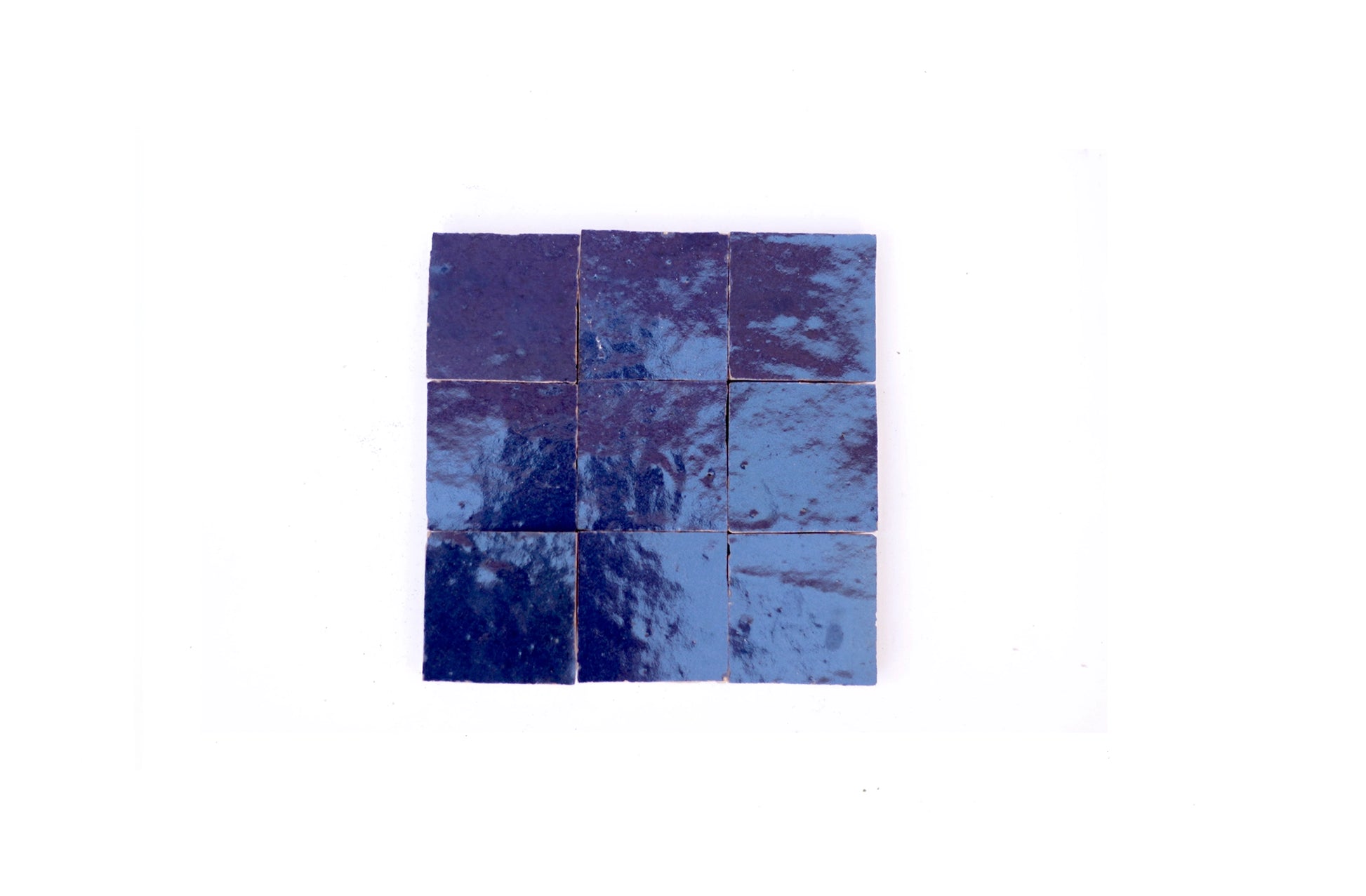 Handcrafted deep indigo Moroccan Zellige tiles, 4x4 inch square with glossy glazed finish, perfect for kitchen backsplash, shower wall, or accent feature