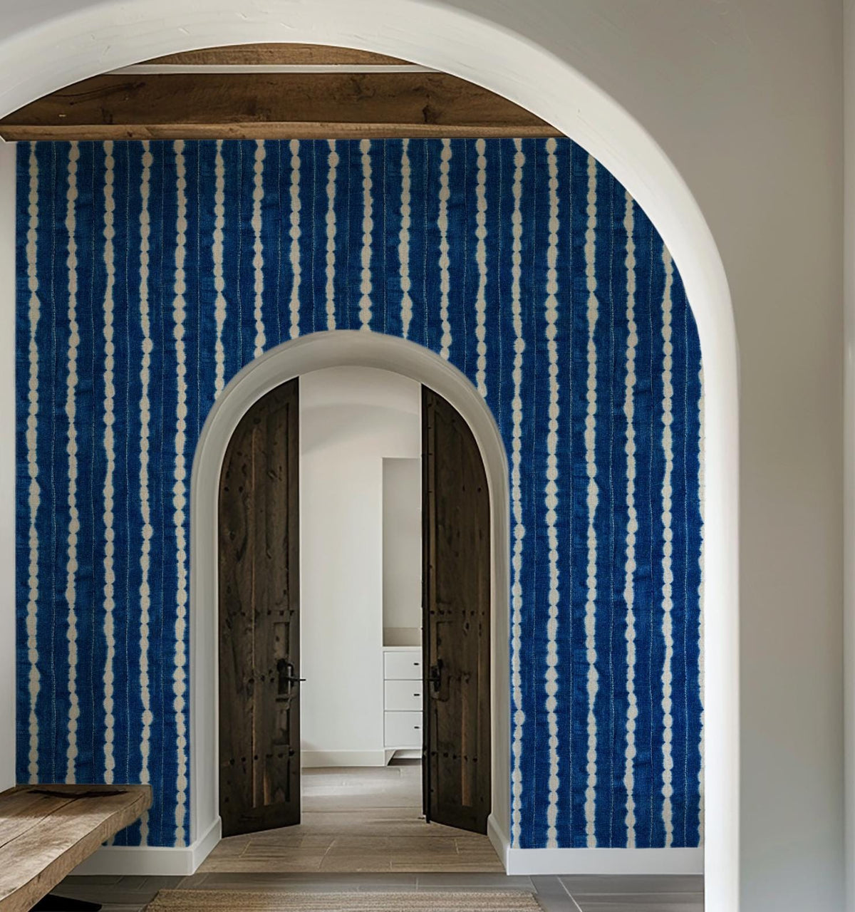 Indigo wavy-stripe wallpaper around an arched doorway, House of Anouar