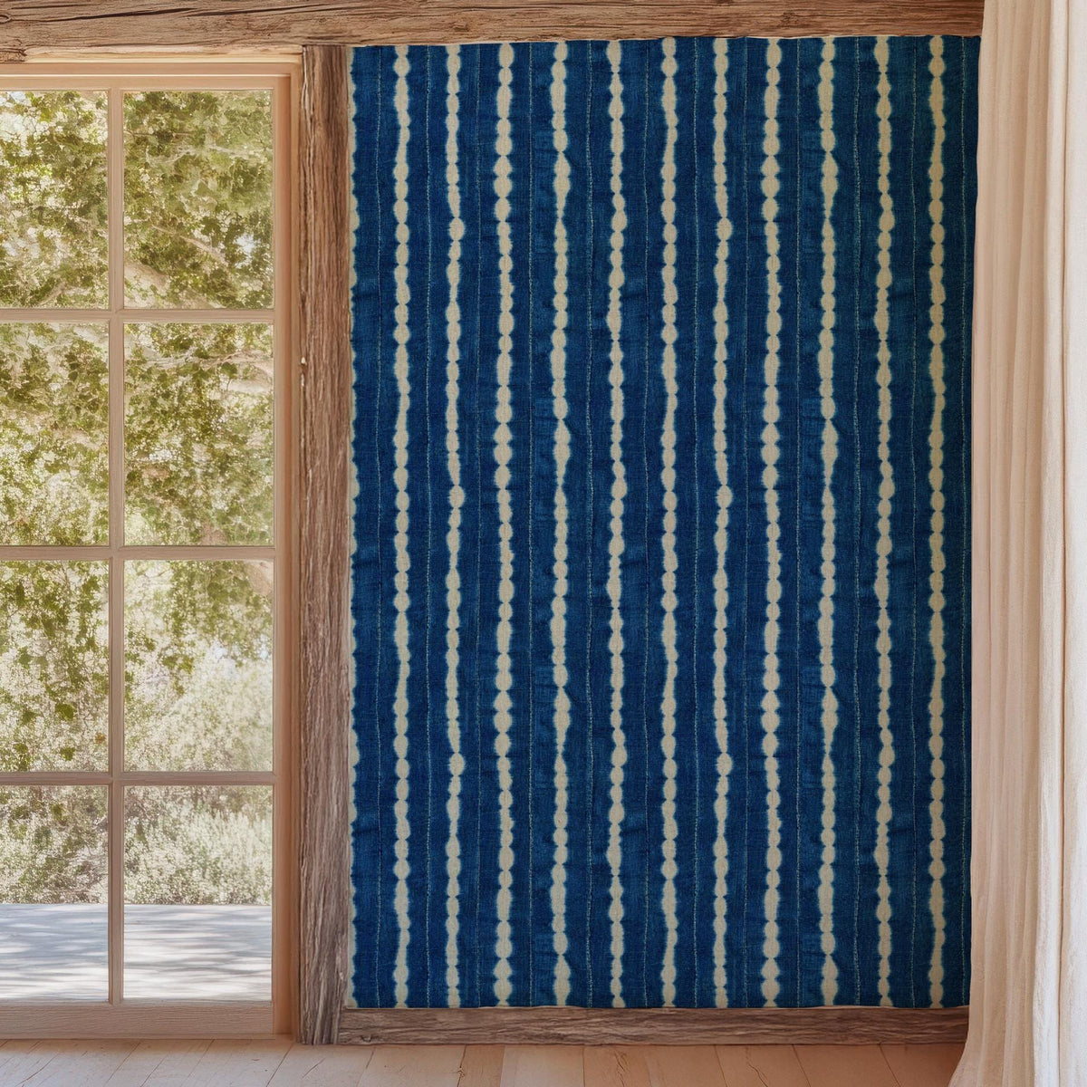 Indigo wavy-stripe wallpaper beside a garden doorway, House of Anouar