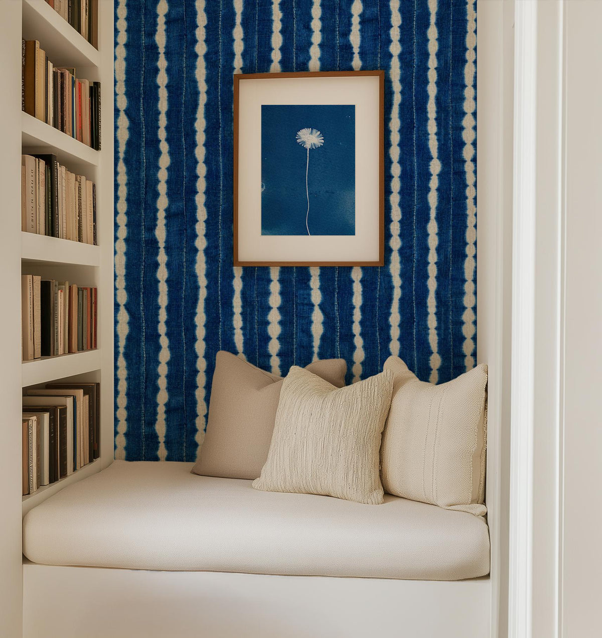 Indigo wavy-stripe wallpaper in a cushioned reading nook, House of Anouar