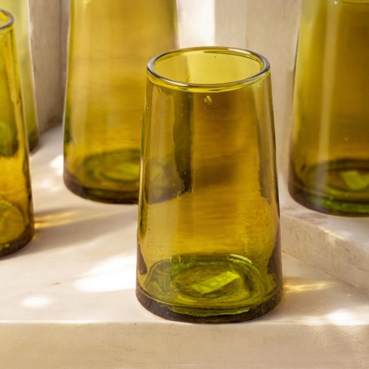 Large olive green Moroccan Beldi drinking glasses on a stone surface, House of Anouar