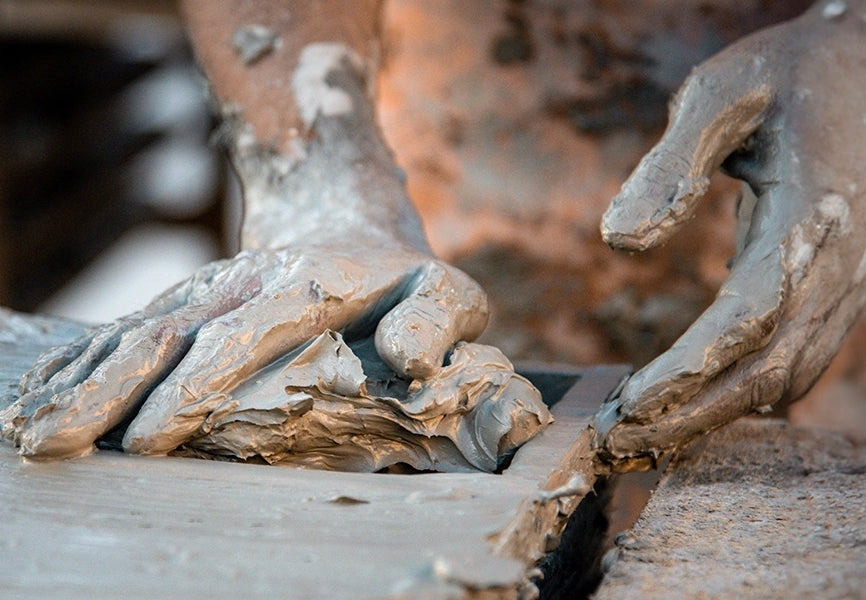 Moroccan artisan shaping raw clay by hand for traditional handmade Zellige tile production process