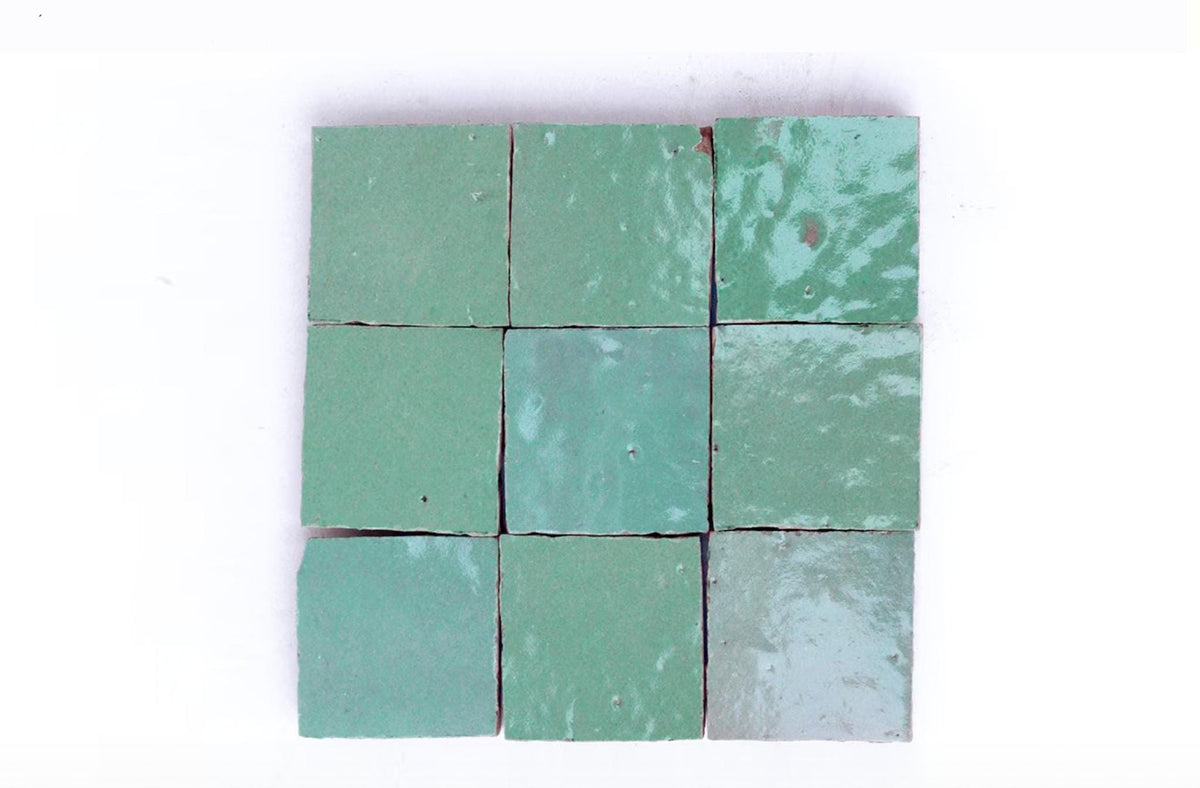 Nine handmade green Moroccan Zellige tiles arranged in a square grid on a white background, House of Anouar
