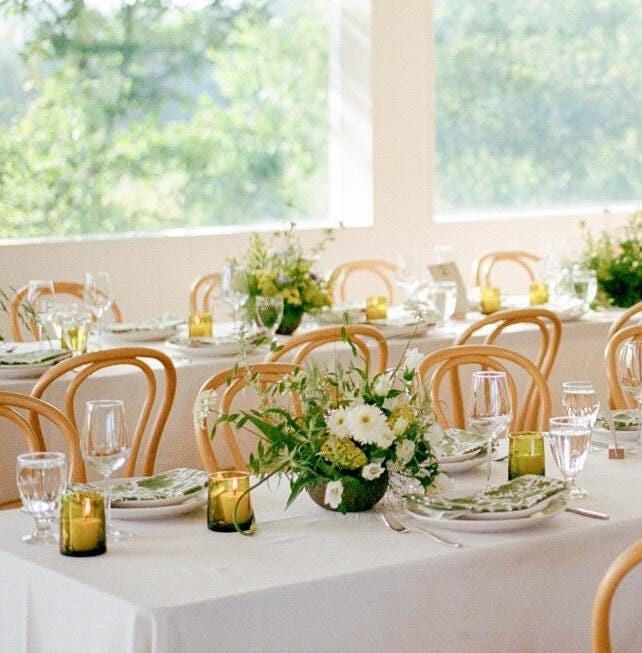 Olive-green Beldi glasses on a floral wedding table, House of Anouar