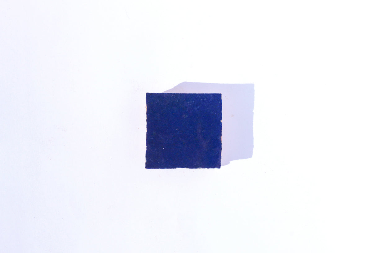 Single dark blue handmade Moroccan Zellige tile by House of Anouar on a white background