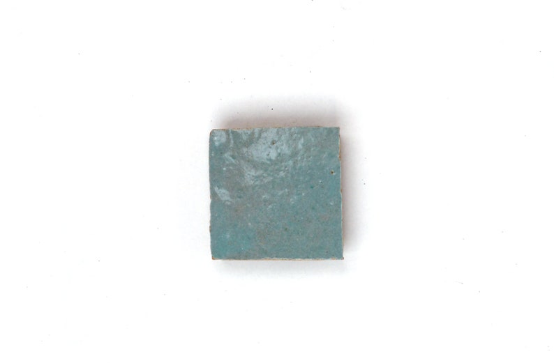 Single handmade light blue House of Anouar Zellige tile on a white background