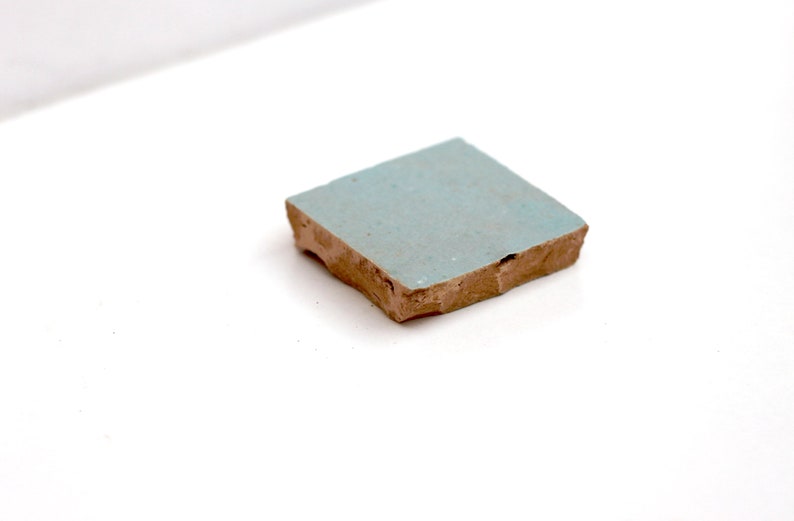 Single light blue handmade Moroccan Zellige tile by House of Anouar on a white background